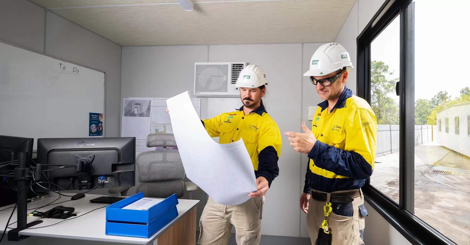 two contractors looking at blue prints